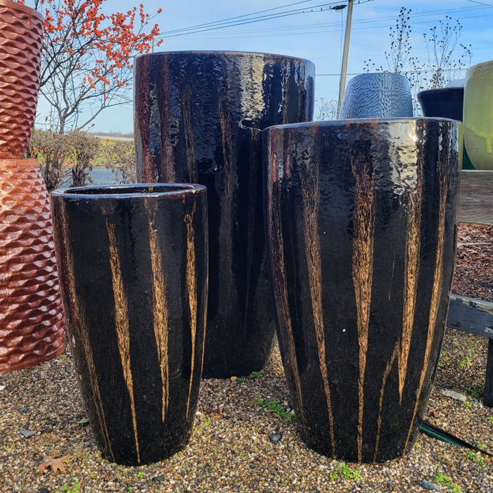 A trio of narrow, rounded, vase-like planters with chocolate stout glaze