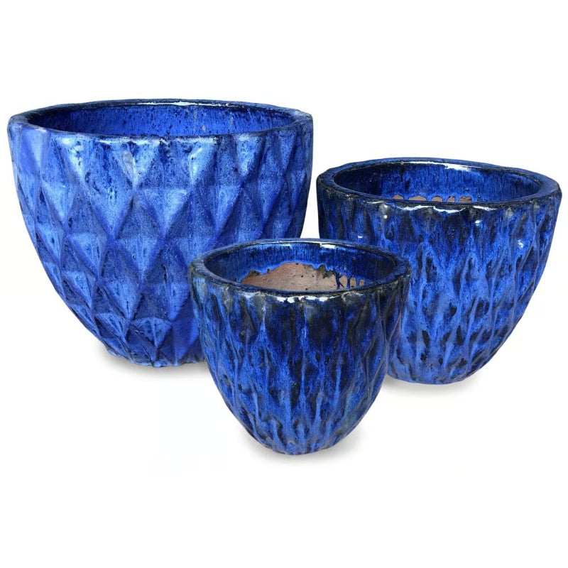 A stock photo of a trio of geometric patterned Diamondplate Egg Pots, finished in a Falling Blue glaze.