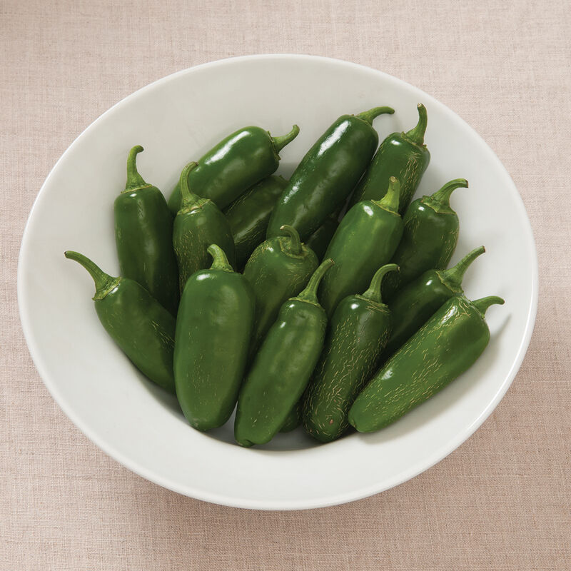 Mature green jalapeño peppers, ready for slicing or stuffing.