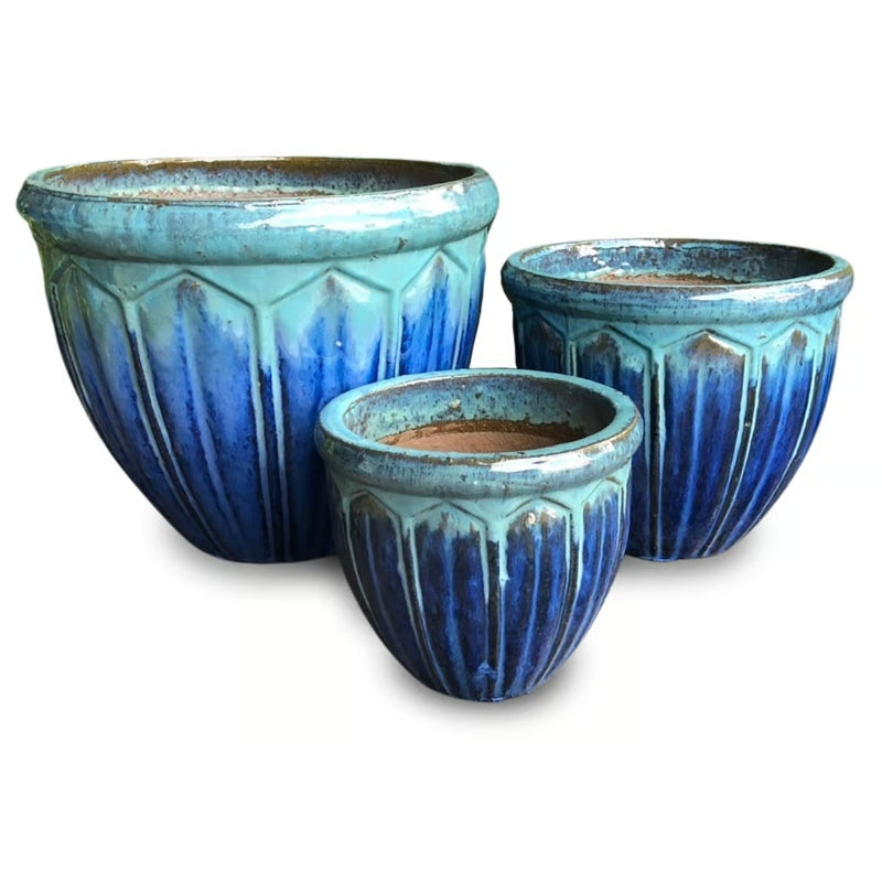 A stock photo of a set of Picket Fence Pots with a geometric fence-post design; finished with a dark blue and jade-green glaze.