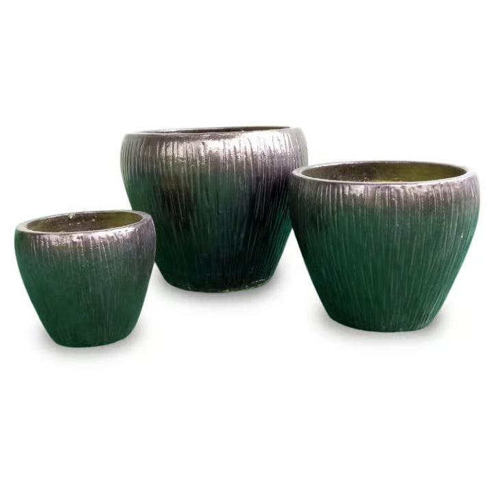 A stock image of a trio of Rounded Tallgrass Egg Pots with lined, grassy design; finished in a metallic Golden Bronze glaze.