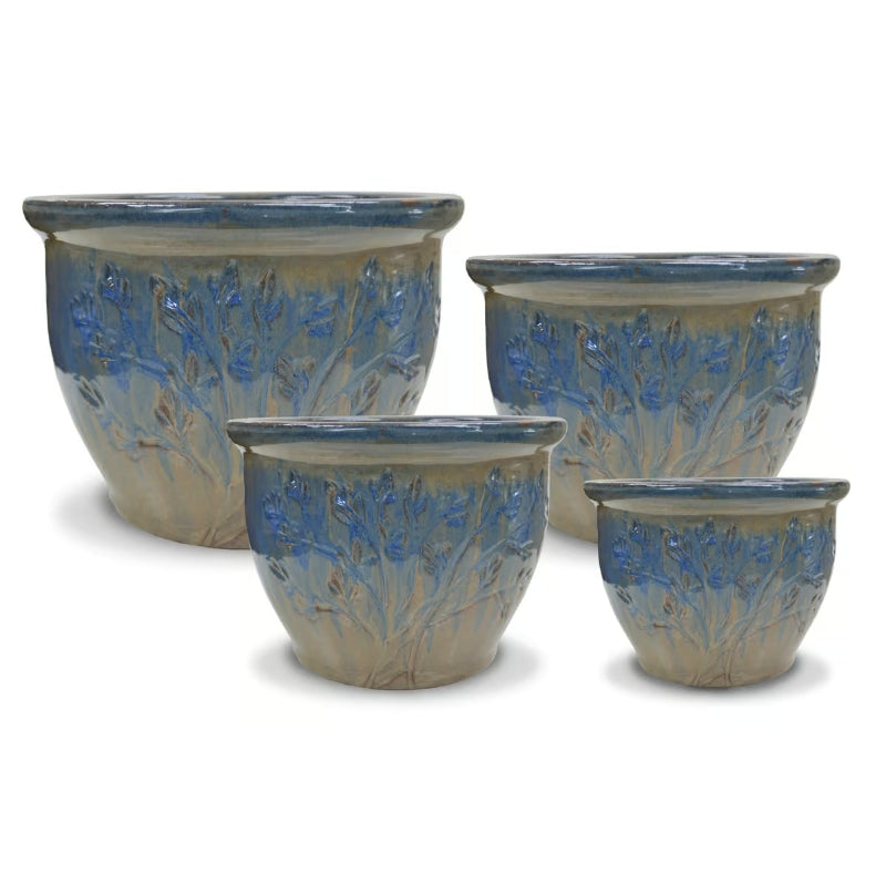 A stock photo of a set of four Cloche Pots with a Tree of Life design, finished with a pale green and blue Earth & Sky glaze.