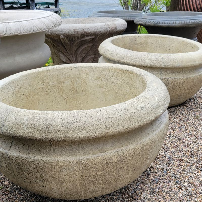 A photo of a pair of Desert Sand Brown 24" Round Rim planters with cupped bowl-like shape and a deep groove around the rim.