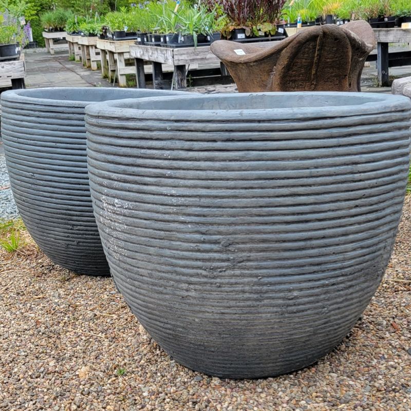 A close-up photo of two Beehive Pots (size Large) with ribbed beehive-like design