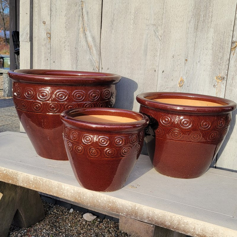 A trio of Bullseye Nina Pots; all decorated with a dark, chocolate brown glaze and a band of decorative bull's-eye elements.