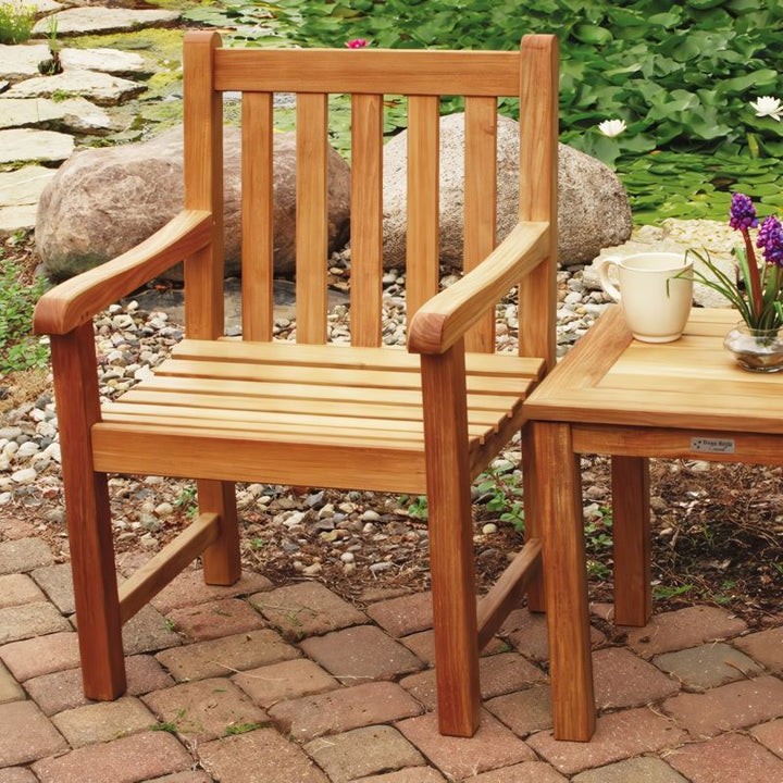 Classic Armchair alongside a Newport 20" Square Side Table in a pond/patio space.