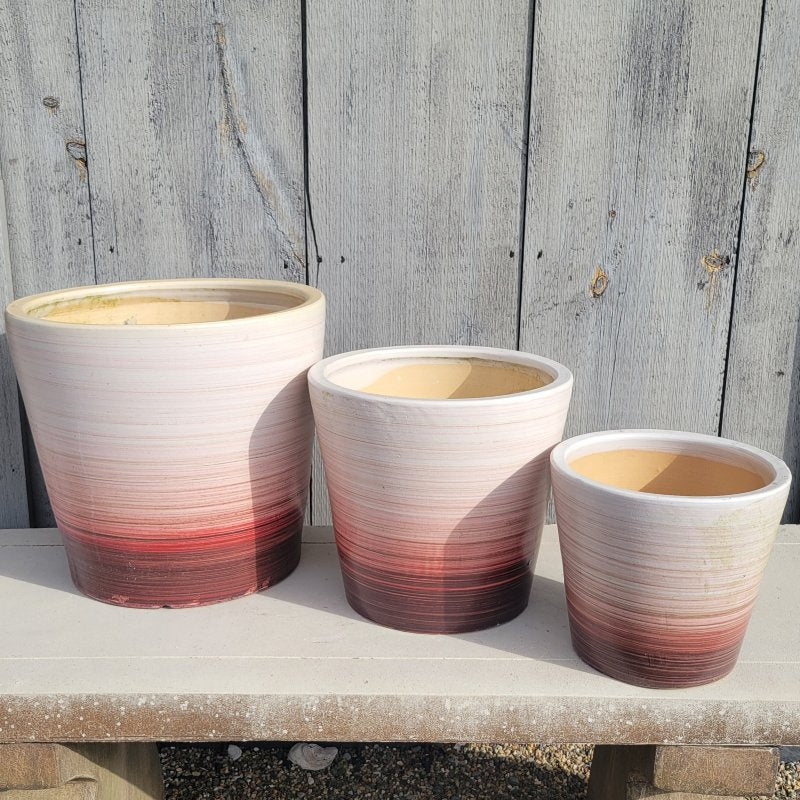 A trio of plain maroon-red to sandy white ombre Desert Strie planters with size comparison.