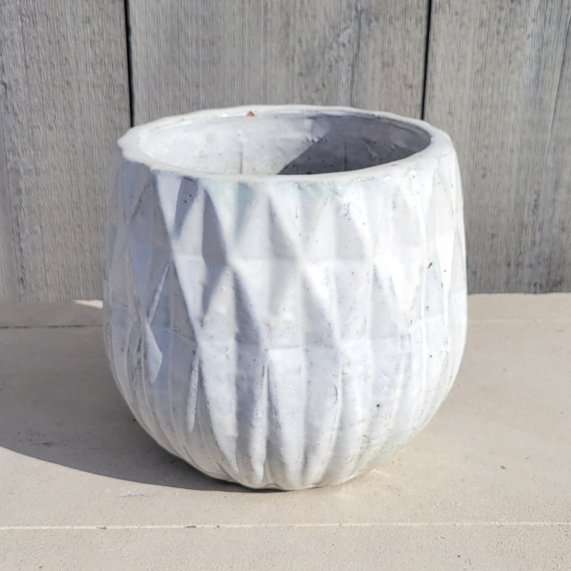 A squat, rounded planter with a sculpted diamond/geometric design and a scalloped lip; finished with a bright white gloss glaze.