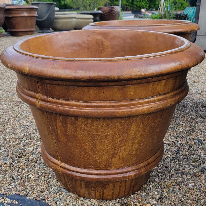 A close-up photo of a large cast-stone Double Rim planter with two pronounced rims below the lip of the pot, finished in Autumn Brown