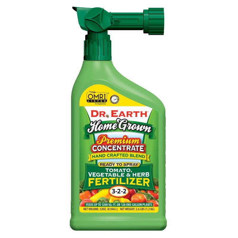 A stock image of a green hose-attachment sprayer bottle of Dr. Earth Home Grown Tomato Vegetable and Herb Fertilizer liquid concentrate