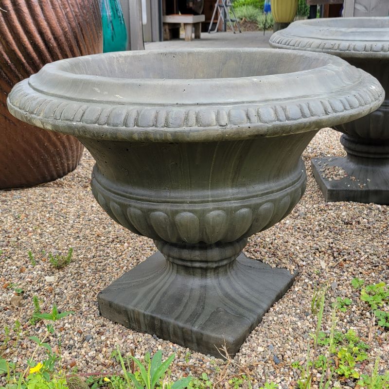 A photo of a large, upright Empire Senior urn with square base, finished in Aged Pine.
