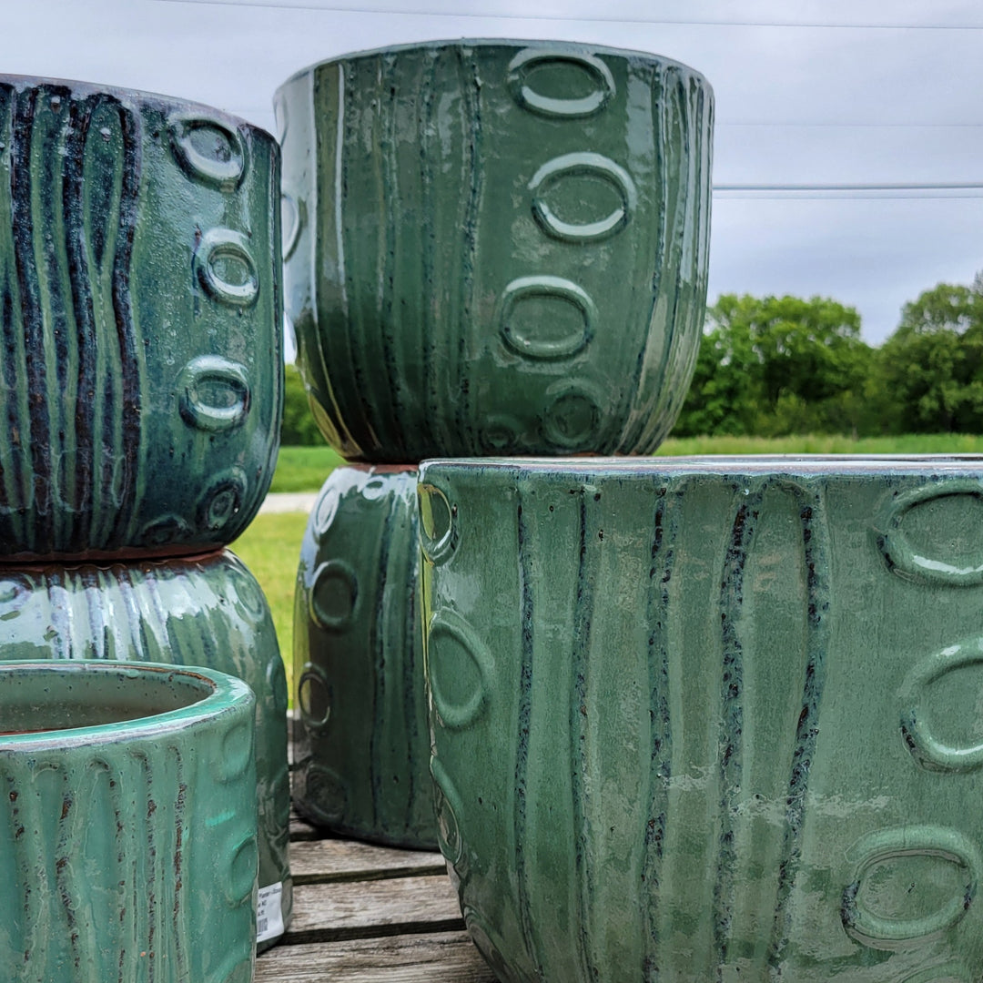 A collection of Falling Water planters with underwater motif design and jade-green/falling blue glaze