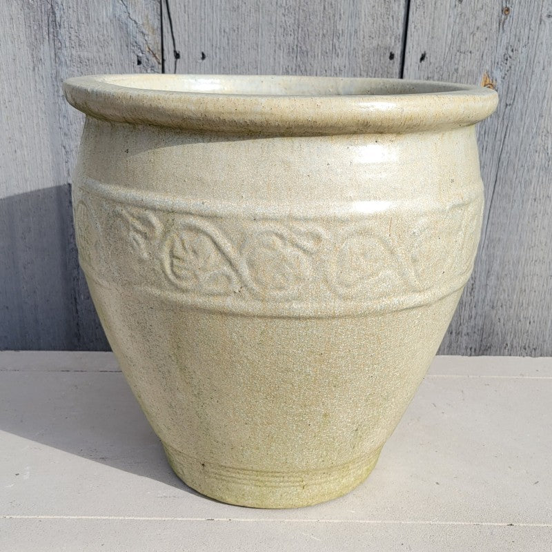 A upright rounded planter with a sculpted faux-Florentine style ring design and a pronounced, urn-like lip; finished in an antique burnished pearl-white glaze.