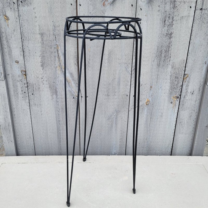 A photo of an upright, black powder-coated Hampton Plant Stand