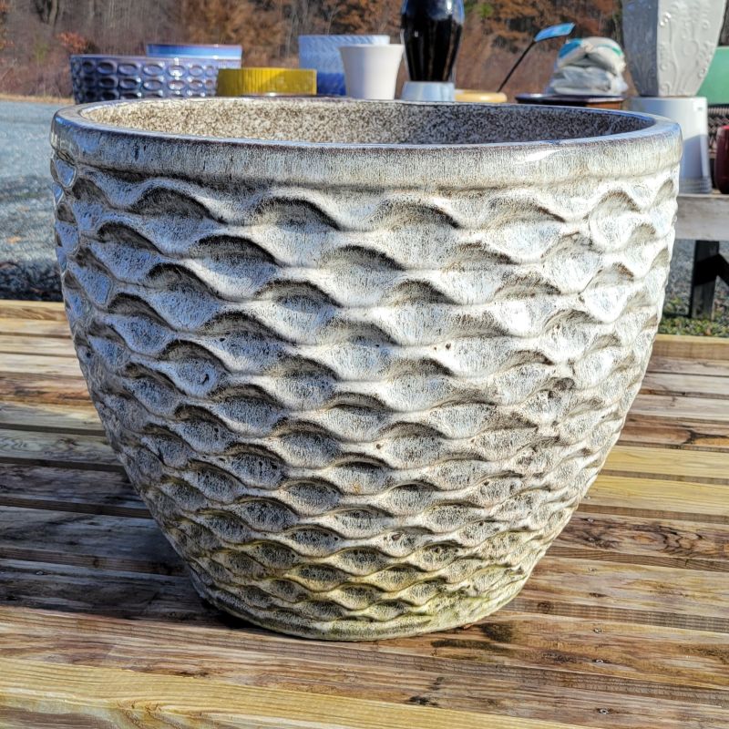 A rounded planter with a sculpted honeycomb texture; finished with a heathered gray glaze.