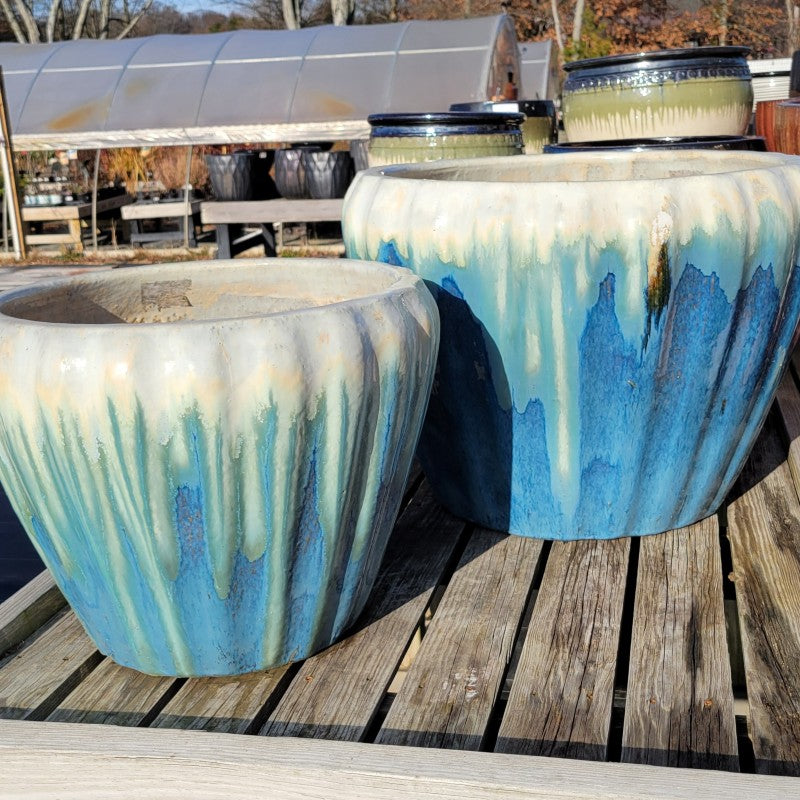 A pair of flared, rounded Honorable planters, one smaller and one larger, with blue to cream-white glazes.