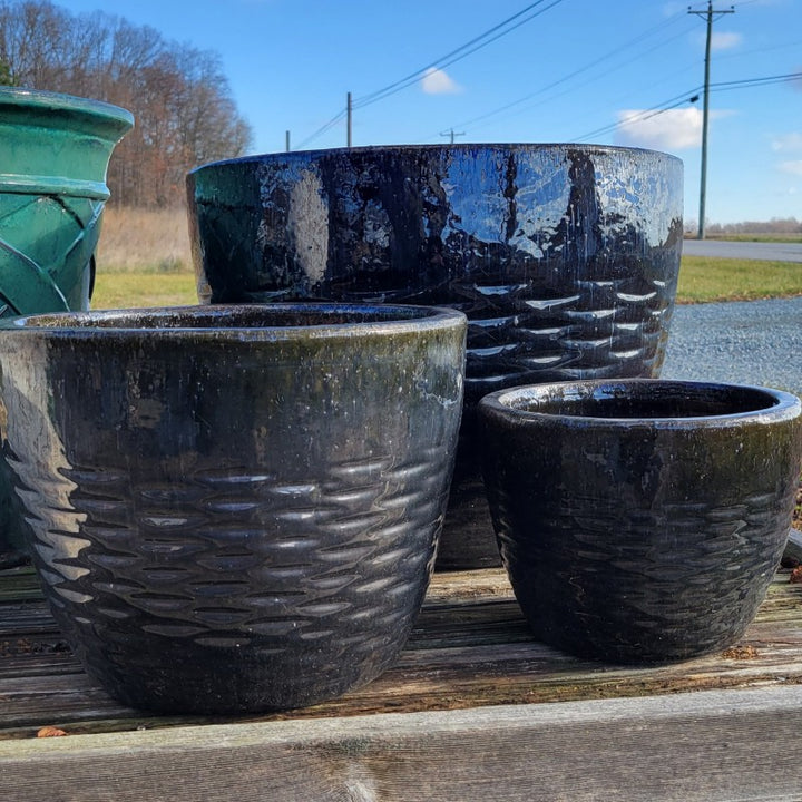 A trio of Hyphen planters, ranging from small, to medium, to extra-large, with pearlescent, multi-color black glaze.