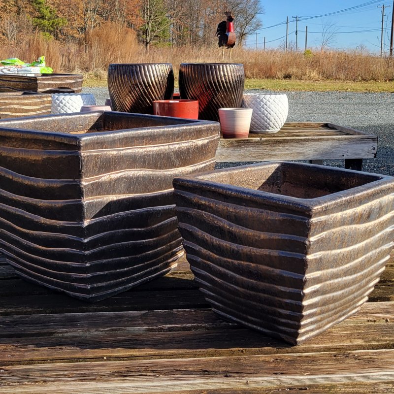 A pair of square, dark bronze glazed Ipanema planters, one large and one small.