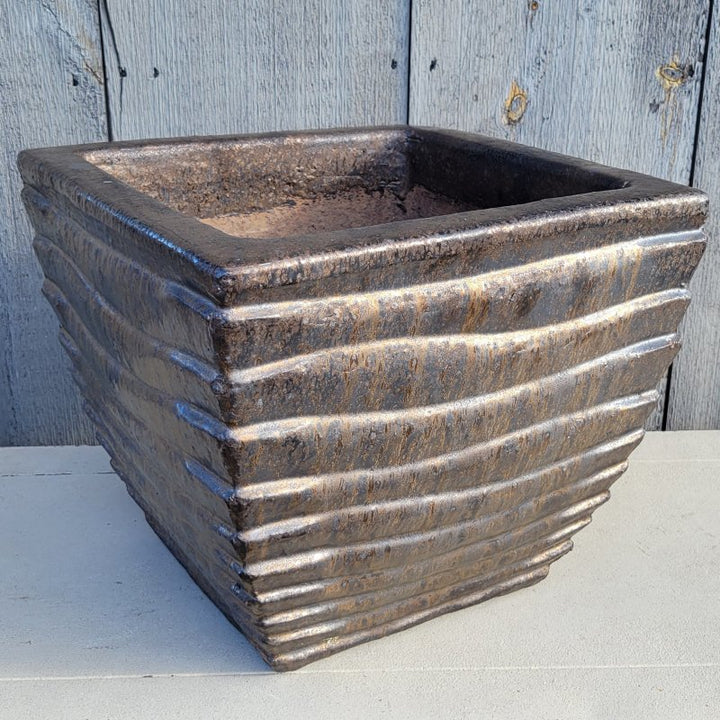 An upright square Ipanema planter with bowed walls and a sculpted ridge design, finished in a dark bronze glaze.