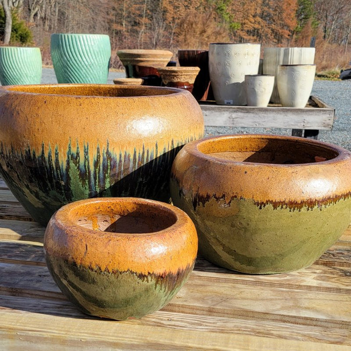 A trio of rounded, bowl-like Maia planters with green and brown glaze; planters are small, medium, and large.