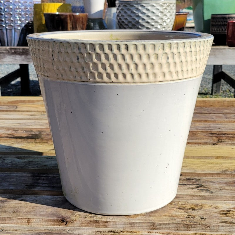 A flared Marcello planter with plain, pale gray glazed base and an upper lip with carved divot design; the lip is finished in a cream-white glaze