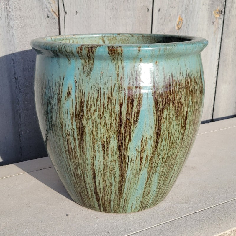 A rounded planter with bowed walls and a pronounced rim; finished with a sea-foam/jade green 'Glacier' glaze.