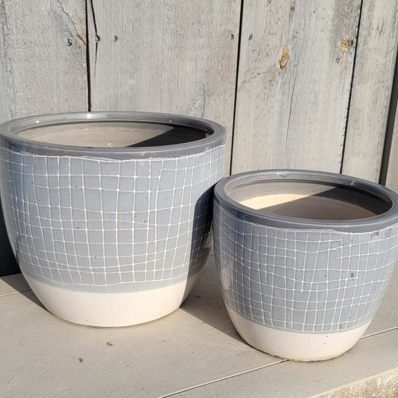 A pair of rounded Mittens Cachepot planters in white and various shades of gray.