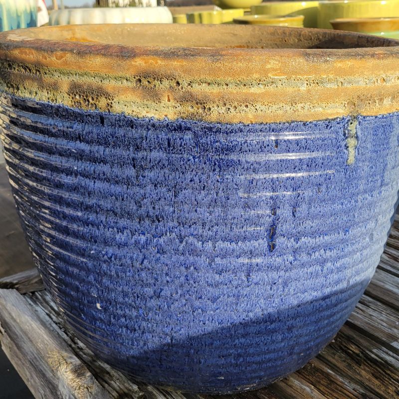 One of the unique Nevis planters, with a sandy colored rim and a dark, sea-blue base.