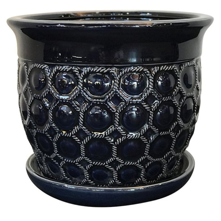 A stock photo of a small, rounded planter with built-in saucer and a sculpted net and bubble pattern; finished in a dark, navy blue glaze.