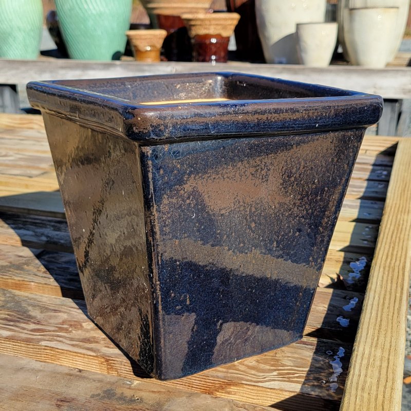 An upright, square Harrison planter with plain sides and a pronounced lip; finished in a reflective, pearlescent midnight blue glaze.