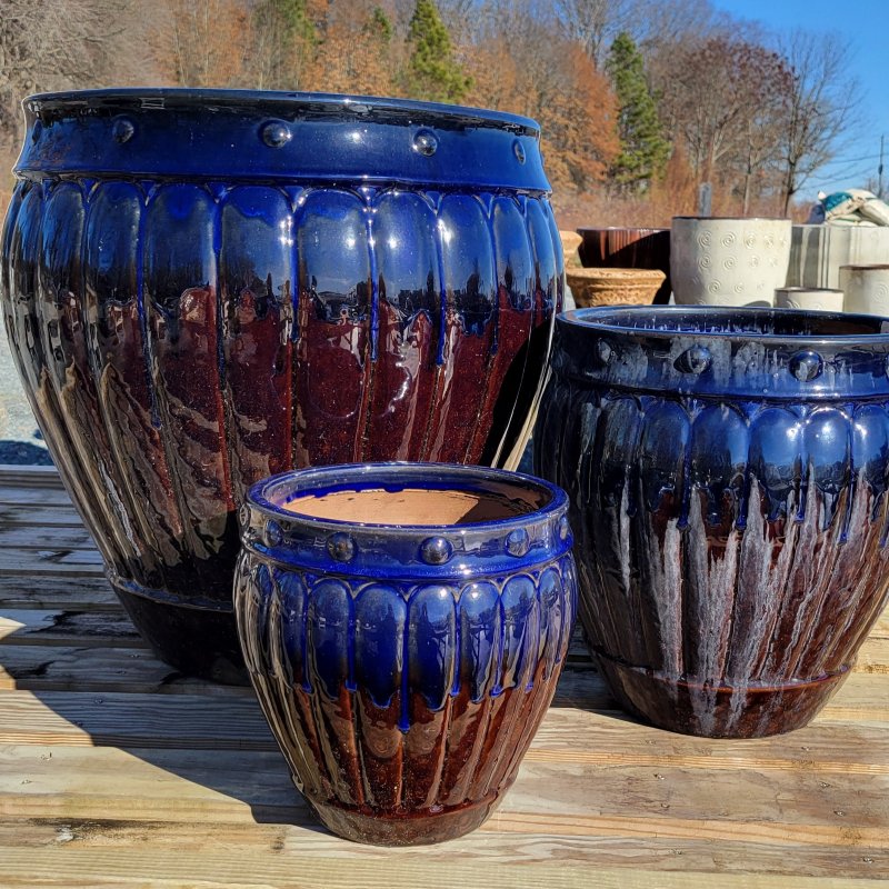 A trio of small, medium, and large Prestwick planters, finished with dark brown and rich blue glazes.