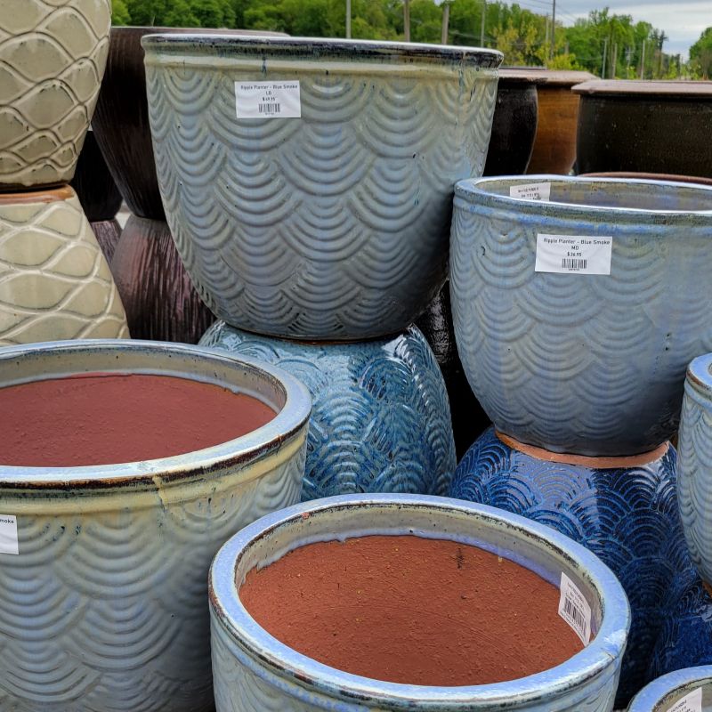 A collection of Ripple Planters in various shades of ocean blue and a number of different sizes