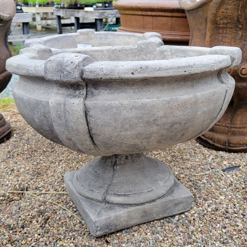 An upright Round Greek Planter with rounded bowl-shaped pot atop a square pedestal