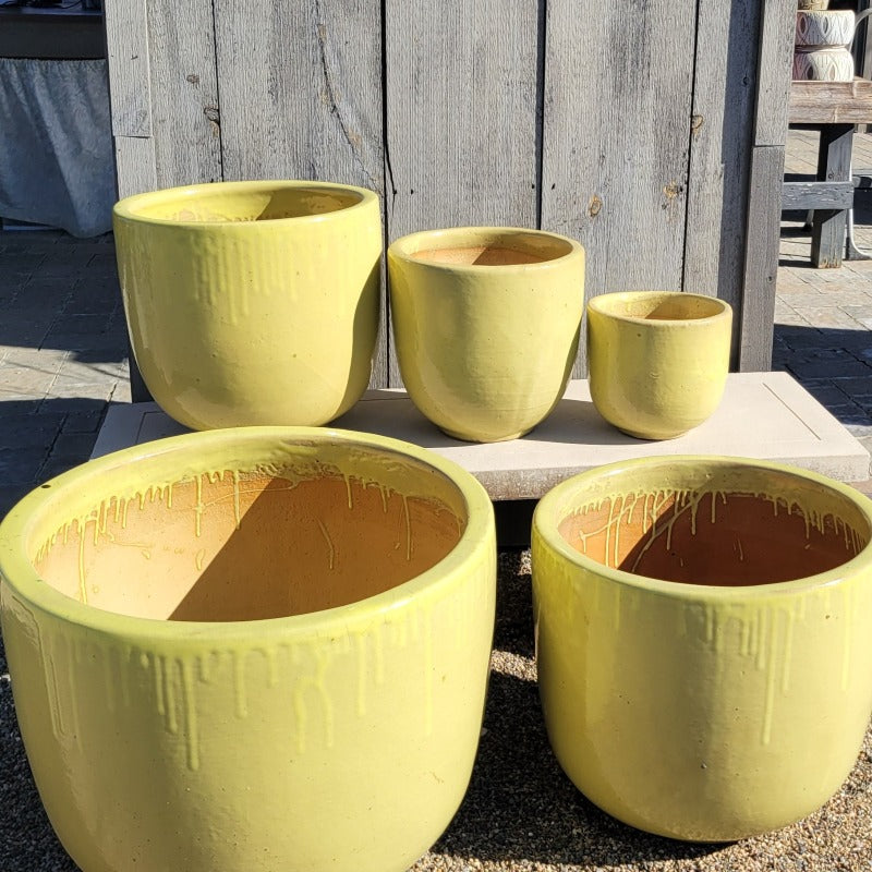 A full set of five Sunshine Yellow Sem Shape Planters with sizes XL and L in the front, and M, S, and XS in the rear.