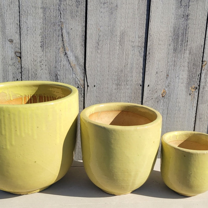 A trio of Sunshine Yellow Sem Shape Planters in sizes Medium, Small, and Extra Small.