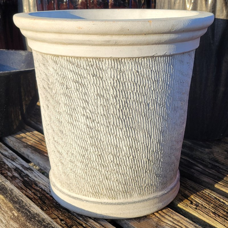 An upright, rounded Shiloh planter with a pronounced lip and a carved cross-hatch line design; finished with a matte stone-gray glaze over raw earthenware.