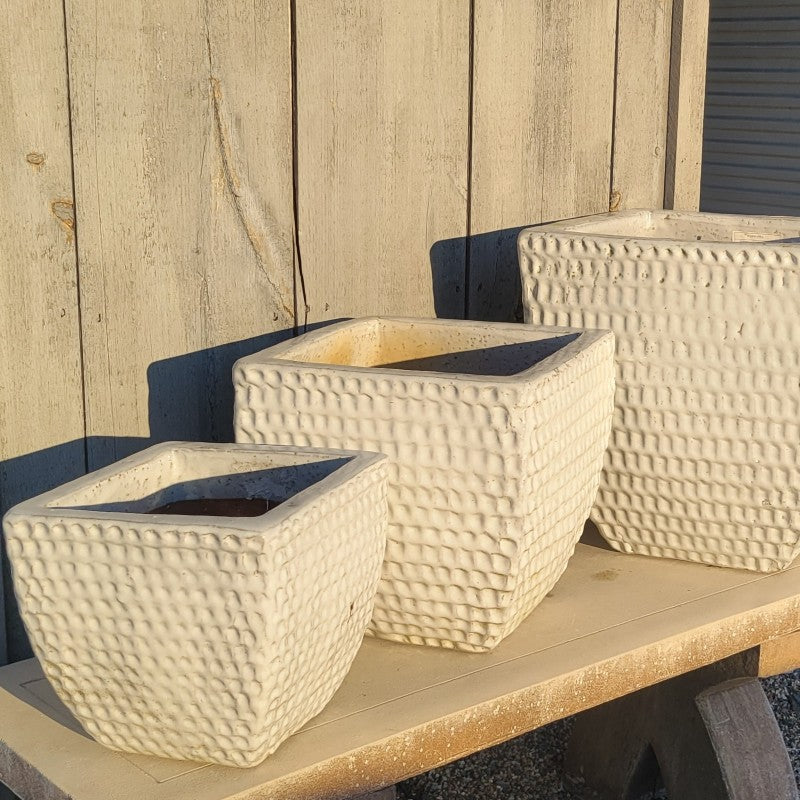 A trio of Square Dimple Planters with bowed walls and white glaze. Planters are small, medium, and large.