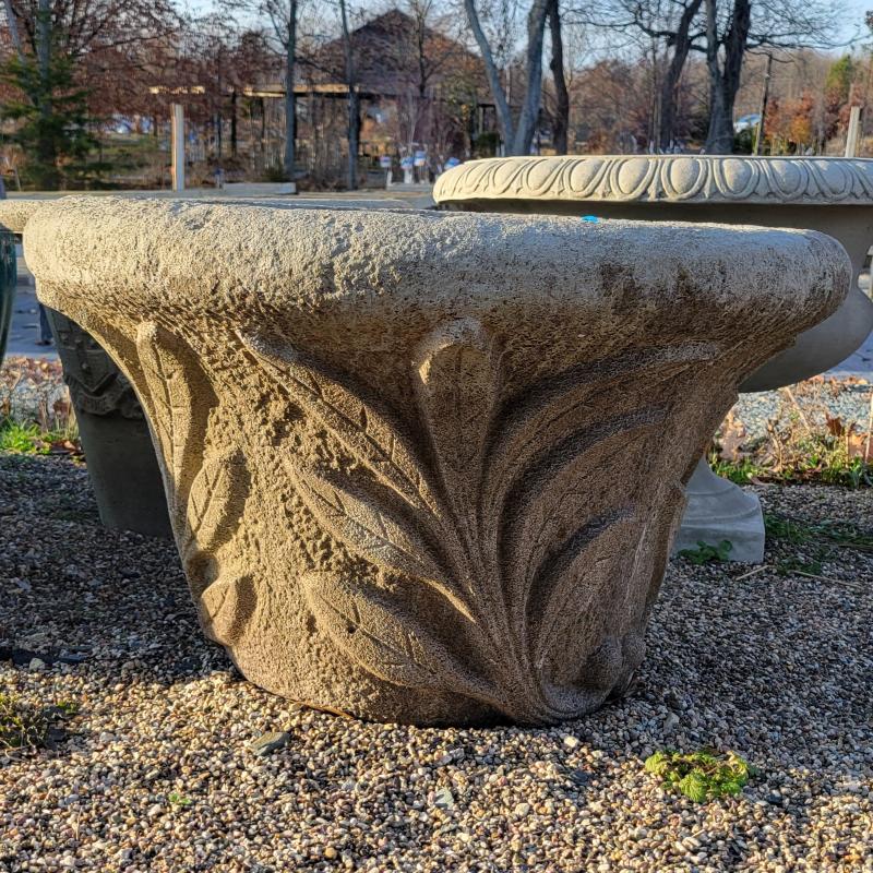 A large, flared, rounded cast-stone Super Leaf planter, decorated with a relief-style leaf frond design around the base.