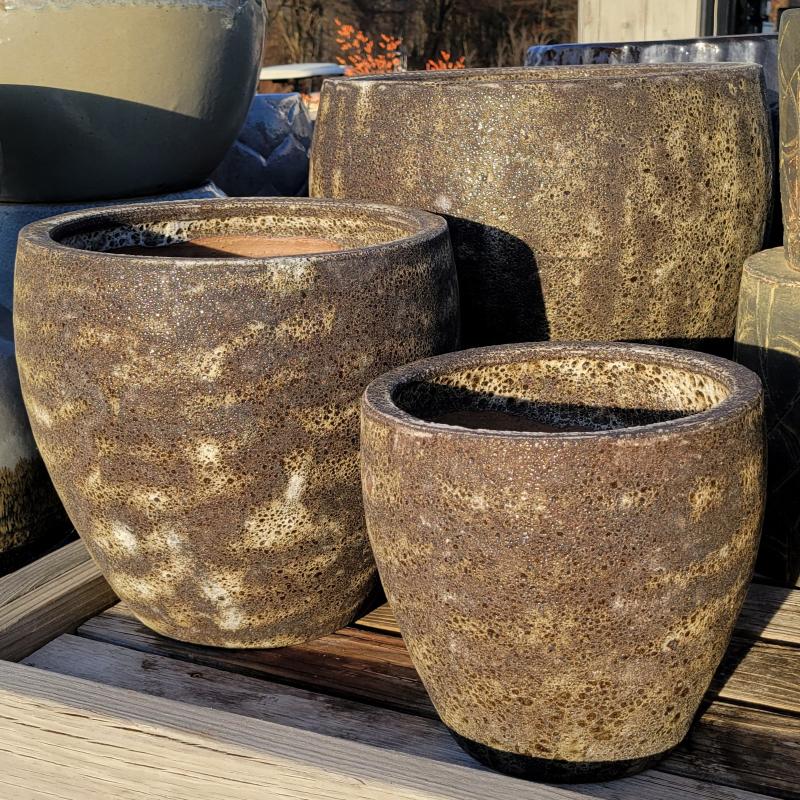 A trio of Symi planters with rough, natural-toned glazes.