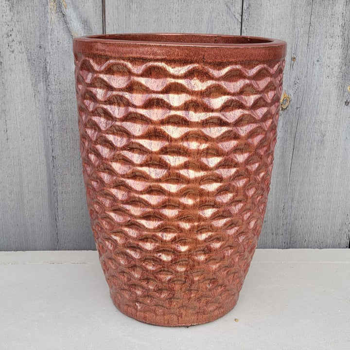 An upright, rounded Tall Honeycomb Planter with a sculpted honeycomb texture; finished with a speckled, metallic red glaze.