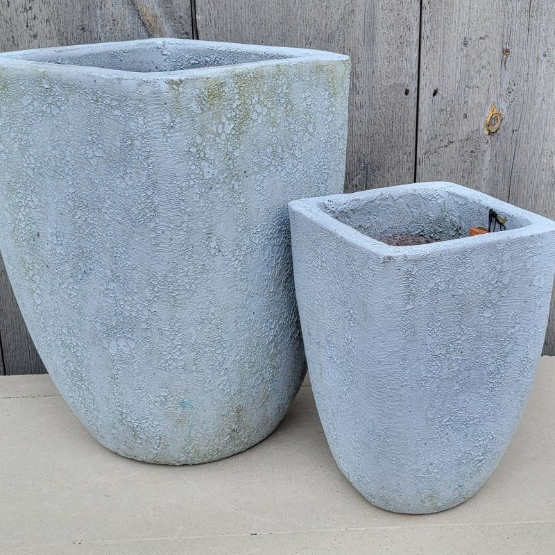 A pair of upright Teo Planters with coral glaze, one small and one medium.