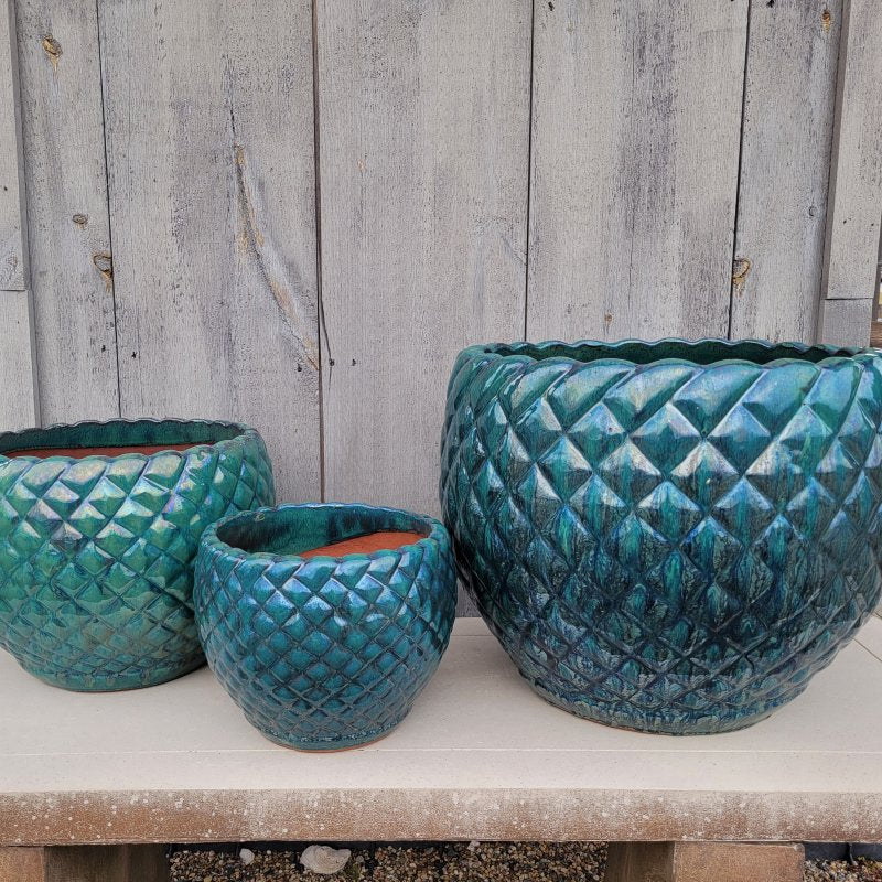 A trio of rounded Teresa Planters finished in a dark blue-green glaze; the trio is small, medium, and large.