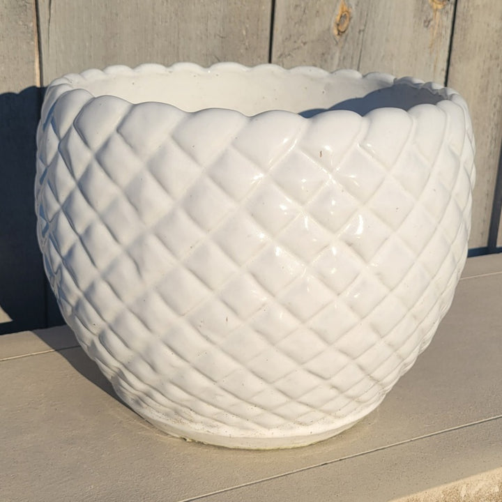 A rounded Teresa Planter with carved geometric square design and scalloped lip; finished in a glossy white glaze.