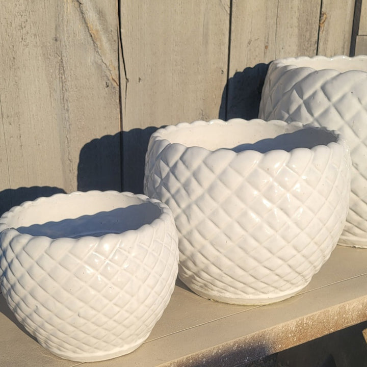 A trio of rounded Teresa Planters finished in a glossy white glaze; the trio is small, medium, and large.