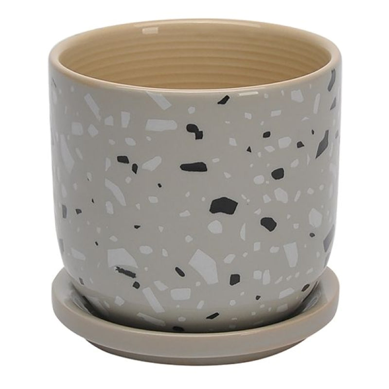 A stock photo of a round, straight-walled planter with built-in saucer; the planter's plain sides are decorated with a gray faux-terrazzo style glaze.