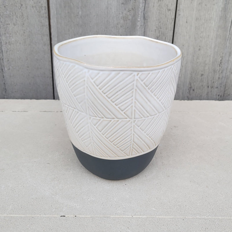 An upright rounded Tikal Planter with removable drainage plug and sculpted geometric line design; finished with a white and gray glaze.