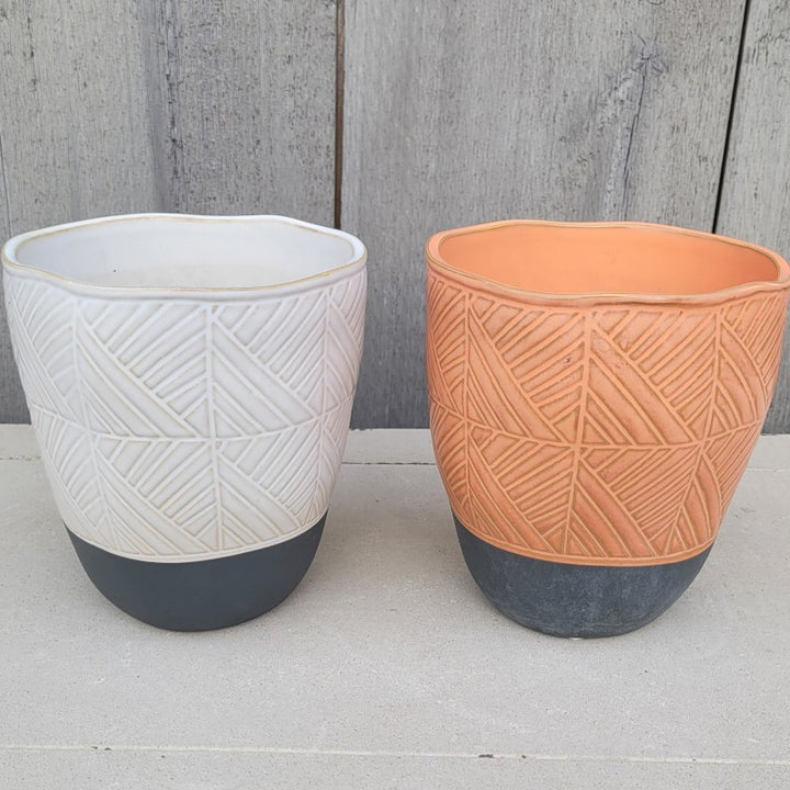 A pair of Tikal planters, available in white and orange.