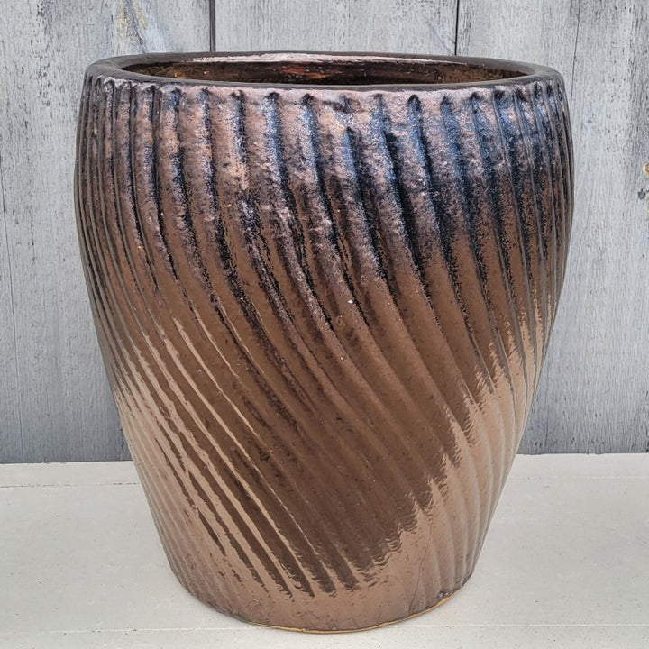 An upright Vortex Planter finished with a  metallic Bronze Dore glaze.